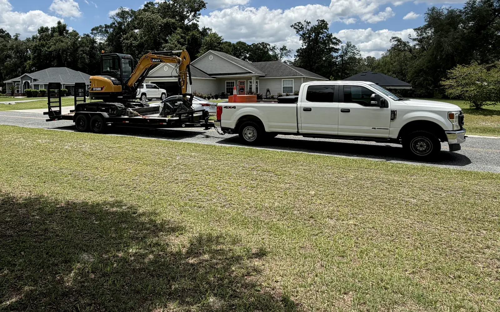 Zach's SANY compact excavator hauled for property work around Lake City